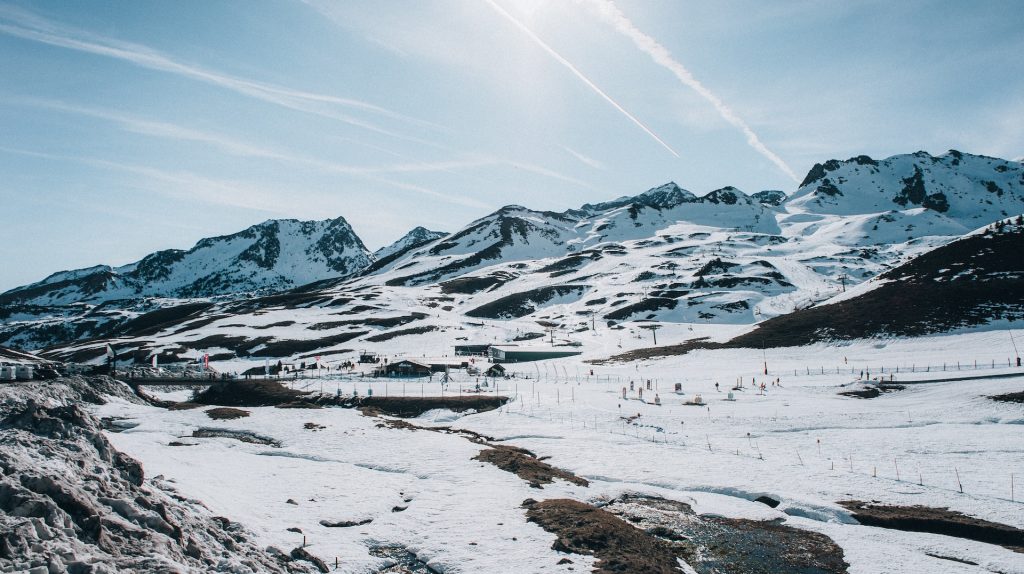 a snow covered mountain with a small stream running through it